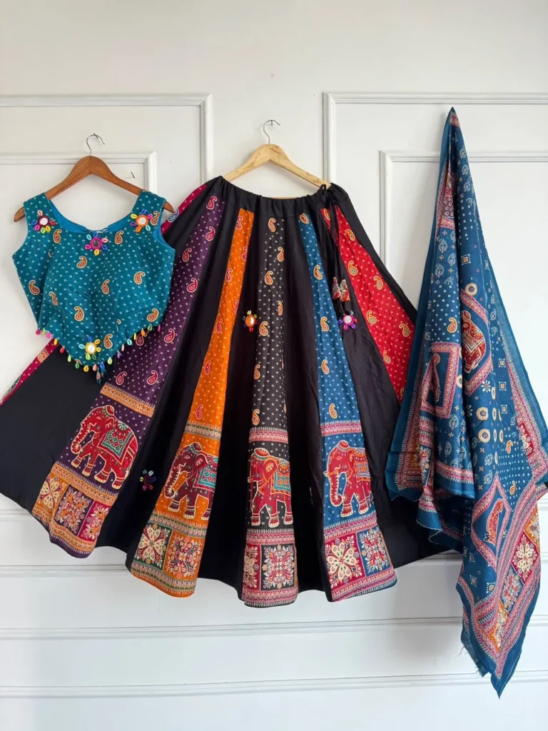 Chaniya choli set with an elephant and paisley print panelled skirt, teal choli and printed dupatta on hangers