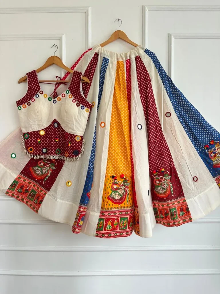 Chaniya choli with bandhani-print panels, garba-dancer prints and mirror work on hangers